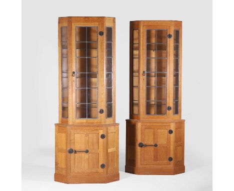 ▲ Robert 'Mouseman' Thompson (1876-1955), a pair of oak corner cabinets, each with a glazed cupboard enclosing three glass sh