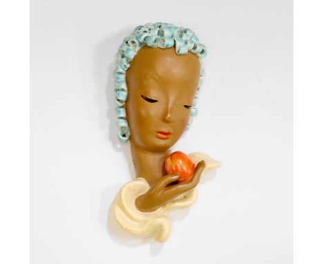 Rudolf Knörlein (Austrian, 1902-1988) for Goldscheider, a pottery wall mask, c.1930, 'No. 6774', modelled as a lady holding a