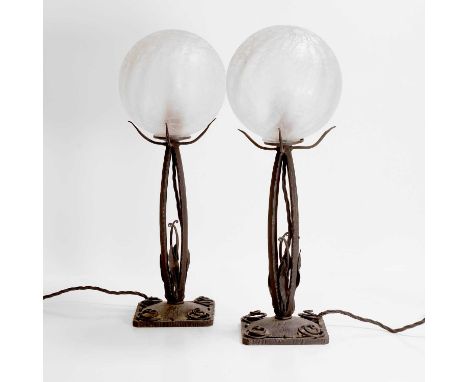 Art Deco, a pair of wrought-iron and glass lamps, 20th century, the globular shades of crackle glass form, with four foliate 