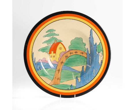 Clarice Cliff (1899-1972), an 'Orange Roof Cottage' pottery charger, c.1930, of circular ribbed form, printed marks,32.5cm di