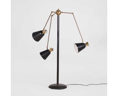 Possibly Italian,  an adjustable three-light floor lamp, 20th century, brass, with black-enamelled shades, base and central c