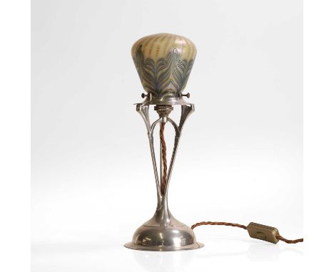 Loetz, an iridescent glass and Osiris pewter table lamp, c.1900, the glass shade with combed iridescent trail, raised on a pe