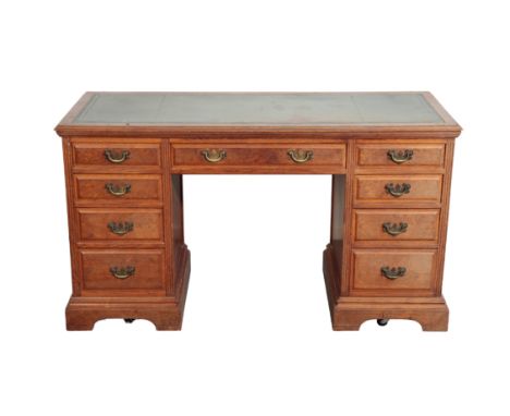 AN EDWARDIAN OAK PEDESTAL DESK with a tooled leather inset writing surface, 77cm high x 137cm wide x 56cm deepFrom The Estate