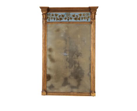 A REGENCY PIER MIRROR of architectural form, the pediment with a blue and gilt verre eglomise panel decorated with a fruiting