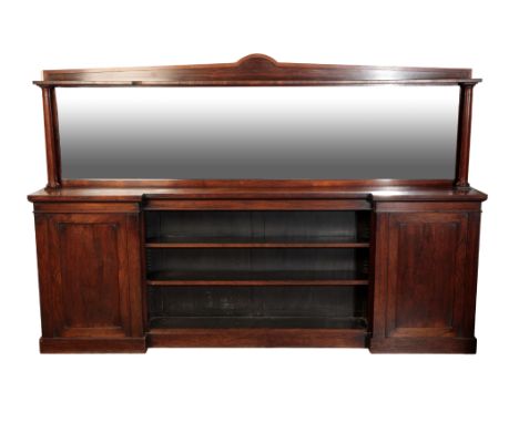 A ROSEWOOD SIDEBOARD first half of the 19th century, with a shaped pediment above a large mirrored plate, with an inverted br