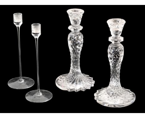 A PAIR OF CUT-GLASS TABLE CANDLESTICKS the baluster bodies with a spreading foot, 25cm; and another pair of glass candlestick