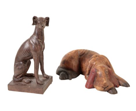 A CARVED WOODEN MODEL OF A RECUMBENT BLOODHOUND, 26cm; and another of a seated dog (2)From The Estate of John Whitwell MS, FR