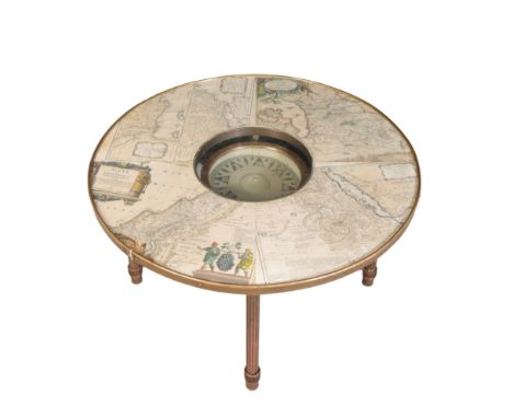 A BRASS 'COMPASS' COFFEE TABLE the circular top with a central clear circle, allowing view of a large compass suspended benea