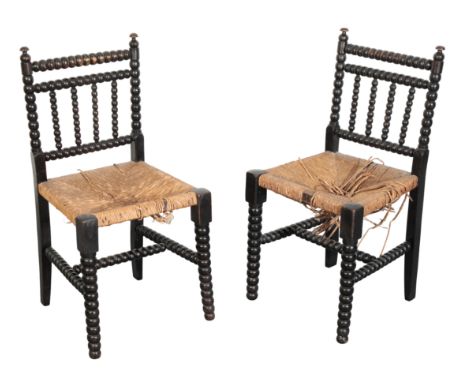 A PAIR OF VICTORIAN EBONISED BOBBIN FRAME CHAIRS with caned seats, 83cm high  (2)From The Estate of John Whitwell MS, FRCS, '
