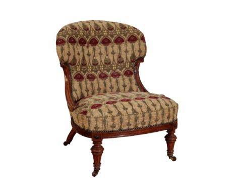 A VICTORIAN WALNUT SPOONBACK CHAIR covered in an Art Nouveau print fabric, on turned and fluted front legs and castors, 80cm 