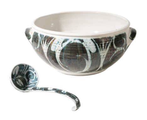 A STUDIO CERAMIC PUNCH BOWL of ovoid form with simple loop handles, decorated with a stylised green glaze, with a ladle ensui
