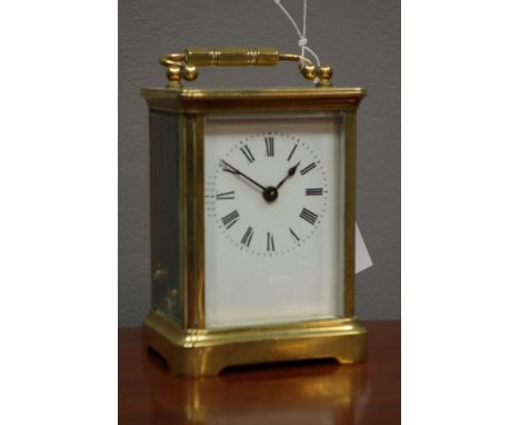 Early 20th century brass carriage timepiece with white enamel Roman dial,plain case with bevelled glass panels, H14cm   Condi