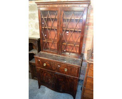 George III secretaire bookcase with three internal bookshelves, behind diamond glass doors, pull out writing shelf, above two