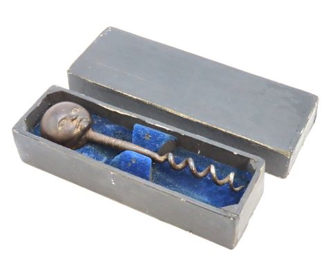 A Victorian corkscrew with carved face handle