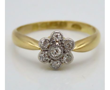 A pretty 18ct Chester gold daisy ring set with seven bright diamonds of approx. 0.15ct, date mark for 1916, maker R.N, 2.2g, 
