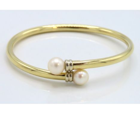 An 18ct hollow gold torque bangle set with cultured pearls, 58mm x 53mm, 13.1g