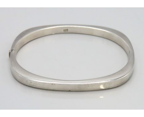 A silver bangle of attractive plain form, internal measurements 62mm x 53mm, 11.7g