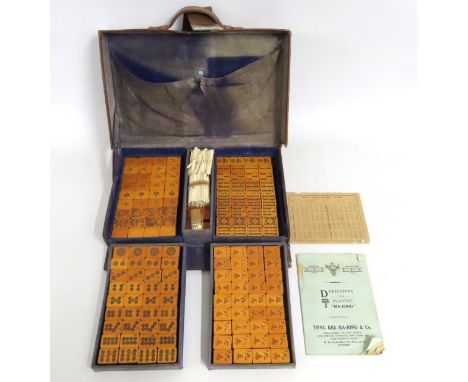 A c.1920's Chinese Mahjong set with bone counters & hardwood pieces with original plush lined leather carry case