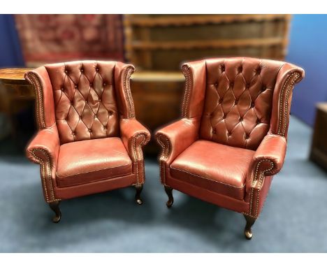 A pair Queen Anne styled burgundy Chesterfield leather wing back chairs with foot rests (not shown), 1060mm high to back x 85