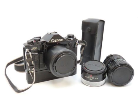 A Canon A-1 35mm film camera with Canon 28mm lens, Canon Zoom lens 35-70mm, a Canon extender 2x-A with two power winders