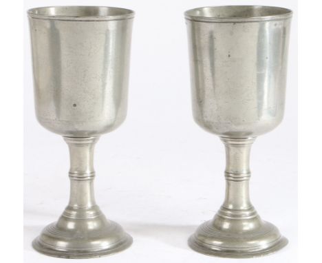 A pair of George III pewter communion cups, circa 1815  Each having a deep and straight-sided flared bowl, (from a truncated 