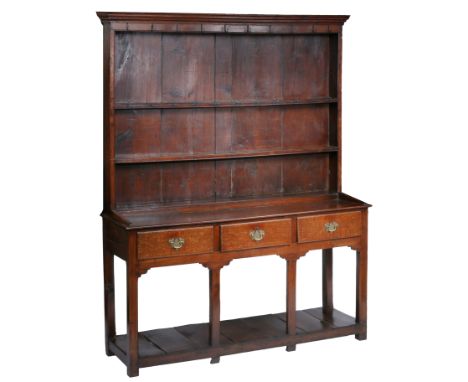 A George III oak high dresser, South Wales, circa 1760  The boarded rack with two shelves, the open pot-board base with rear 