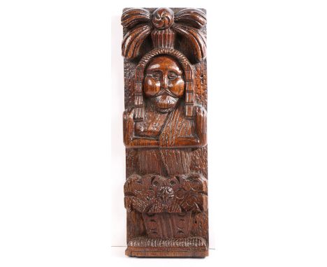 An interesting James I oak figural term, circa 1610  Designed as a male, with beard and moustache, headdress, and angular fol