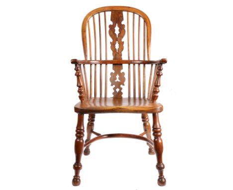 An early 19th century yew high-back Windsor armchair, Nottinghamshire, circa 1830  The hooped back with pierced and shaped fi