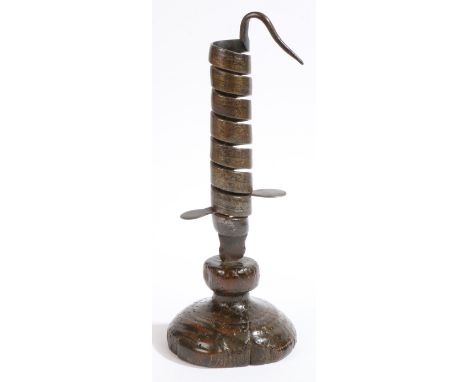 A rare and good English iron spiral candlestick, with turned oak base, probably Penrith, Cumbria, circa 1800 or possibly earl