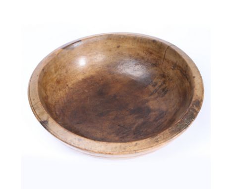 A George III sycamore dairy bowl, circa 1800  With broad canted rim, and decorative ring turnings, flat base, diameter 37cm