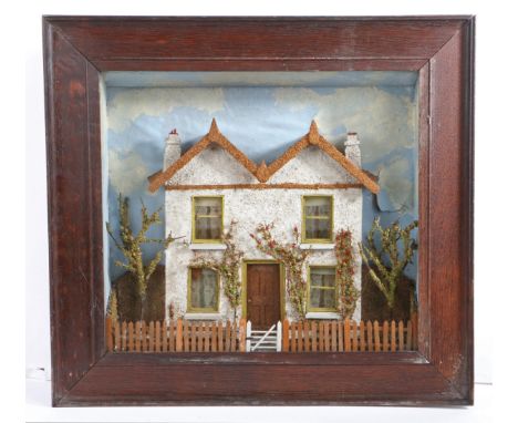 A Victorian cased diorama, depicting a house, circa 1870  The twin-gabled house with cork roof and ‘mica' rendered walls, wit