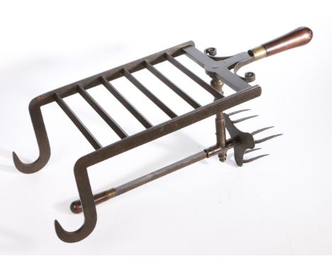 A fine George III iron bar grate lark-spit, circa 1790  The cooking prongs moving backwards and forwards by the brass collare