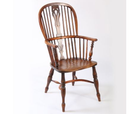 An early Victorian yew and elm high-back Windsor armchair, circa 1840  The hooped back with four long spindles flanking a pie