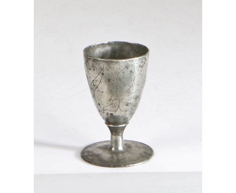 A rare and documented Charles II pewter wrigglework footed ‘wine' cup, circa 1680  The conical egg-shaped bowl designed with 