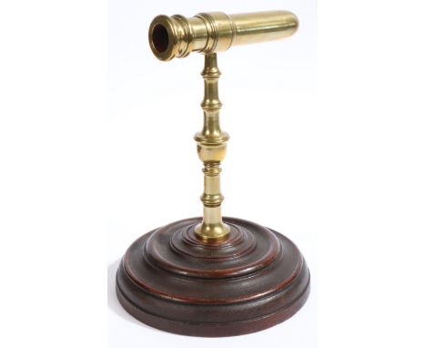 An unusual George III cast brass goffering iron with rare original mahogany base, circa 1790  The moulded barrel fitted throu