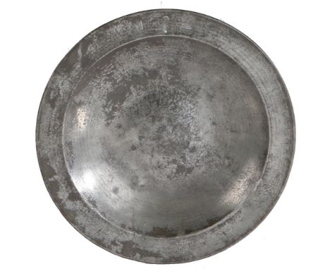 A rare and fine mid-16th century pewter dish, English, circa 1550  The plain rim with triangular beaded edge to the underside