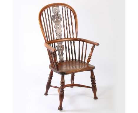 A 19th century yew and elm Windsor armchair, Nottinghamshire, circa 1830  The hooped back with four long spindles flanking a 