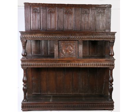 A 16th century impressive oak court cupboard, French, circa 1560-80  Having a back of fifteen panels, including a top row of 