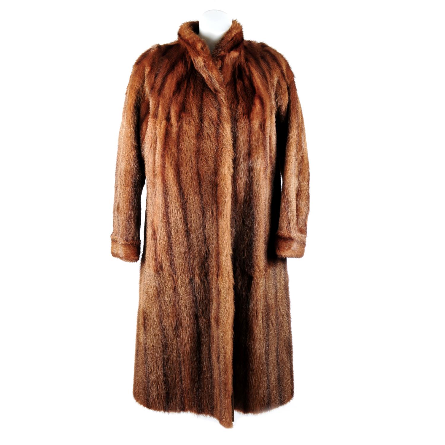 A full-length dyed marmot fur coat. Designed with a lapel collar, hook ...