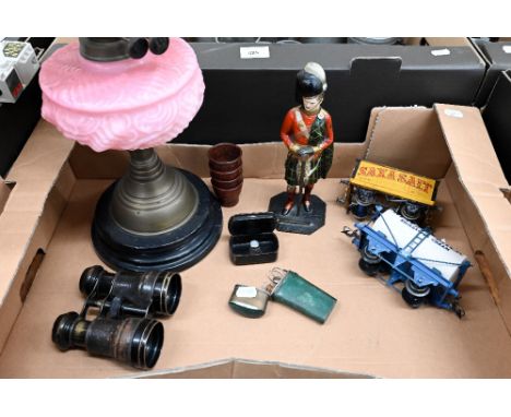 An antique oil lamp with pink glass font to/w a cold-painted spelter figural table-lighter modelled as a Scots Guardsman, a G