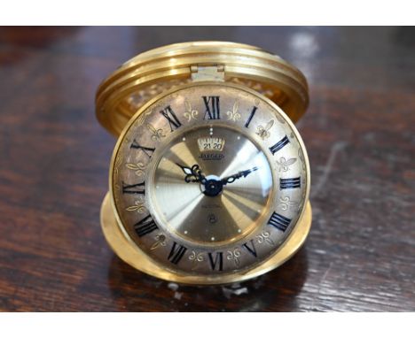 A boxed Jaegar 'Recital' gilt brass travelling alarm clock, 7.5 cm diam