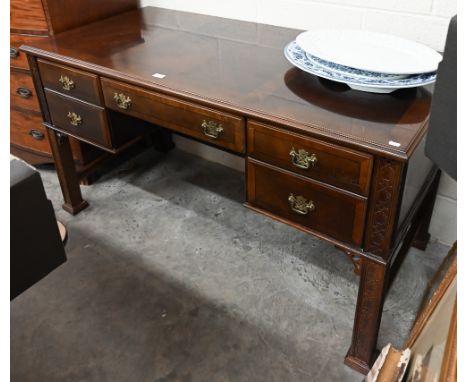 A 20th century Chippendale style kneehole desk with five drawers and blind fret-cut square supports, 146 cm w x 70 cm d x 80 