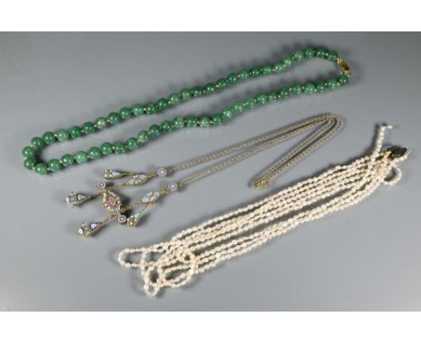 A row of uniform jade beads, knotted onto yellow metal clasp marked silver; an Italian micro mosaic necklace and a four stran