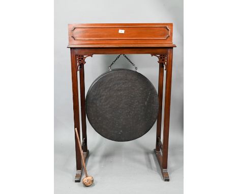 An early 20th century Chippendale Revival walnut gong stand, with heavy patinated brass gong, to/with an associated zinc line