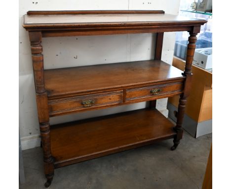 An Edwardian mahogany three-tier buffet with two drawers and turned supports on casters, 104 x 46 x 100 cm high