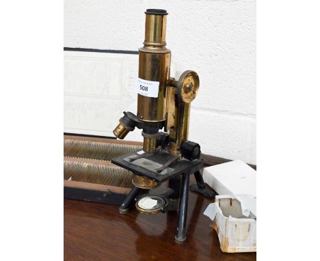 A vintage brass microscope by J Swift &amp; Son, London to/w a box of prepared slides and a quantity of unused slides