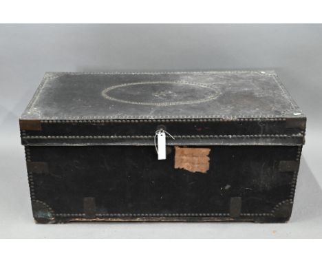 An early19th century Chinese export brass bound and studded leather camphorwood travel trunk, handles to the sides, the inter