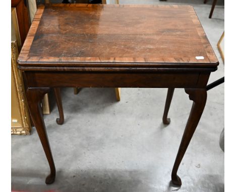A mahogany and walnut crossbanded card table with baise lined rotating folding top with Howard &amp; Sons Ltd retailers plaqu