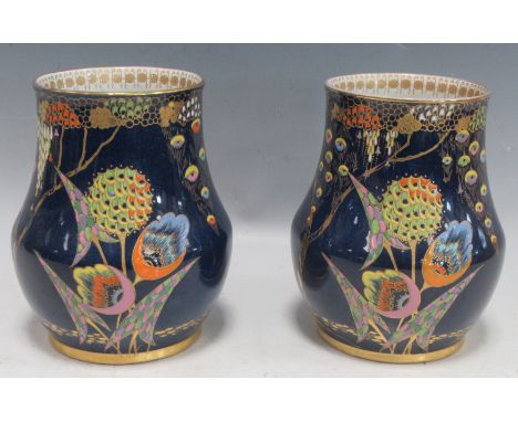 A pair of 1930s Art Deco Carltonware vases decorated in the Devil Corpse's pattern with styalized enamel flowers in a blue gr