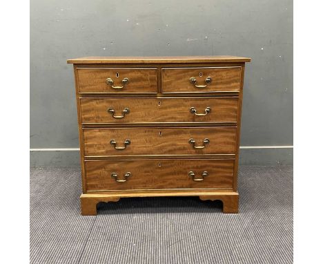 A George III style mahogany small chest of drawers with gilt brass scroll handles, on shaped bracket feetLikely dates to seco